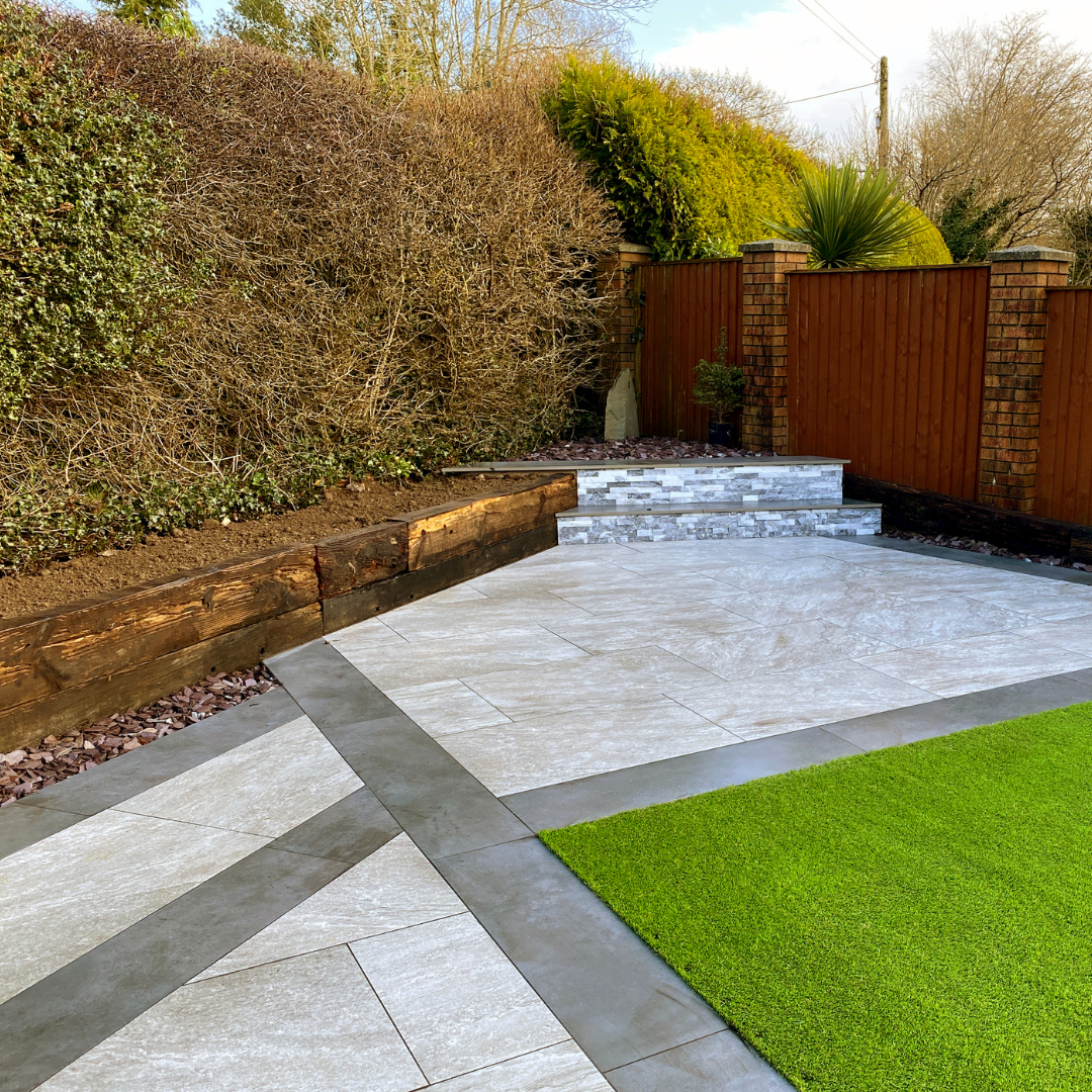 Modern paved garden with steps and artificial lawn
